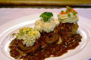 Meatloaf cupcakes with whipped potatoes. roasted corn and dark pan mushroom gravy