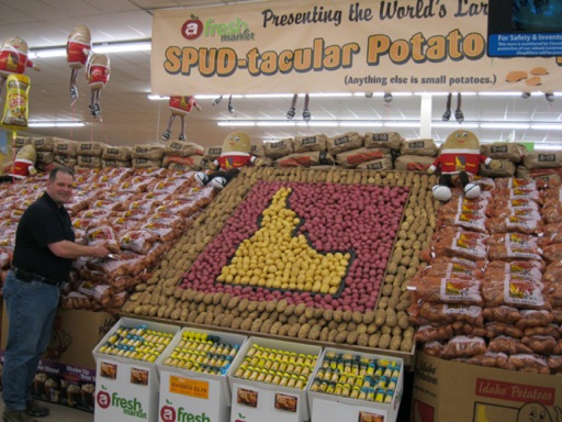 After hours of hard work, Leigh Vaughn, Director of Produce/Floral for Associated Food Stores, places the final bag of potatoes on the World's Largest Idaho Potato Display.